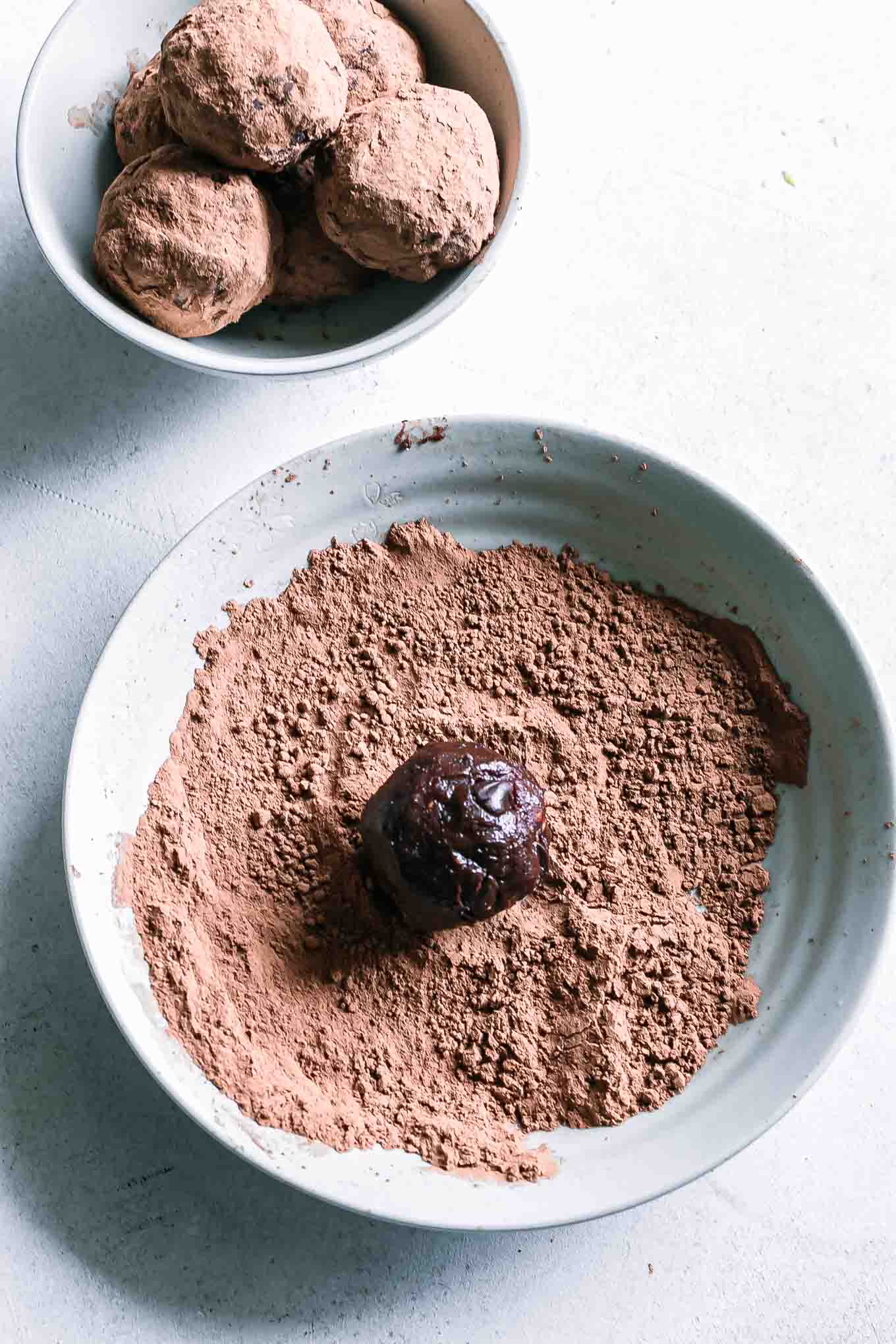 a brownie snack ball on cocoa powder on a plate