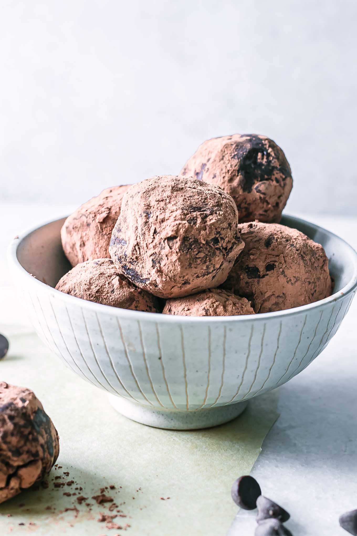 a small bowl of brownie bites on a white table