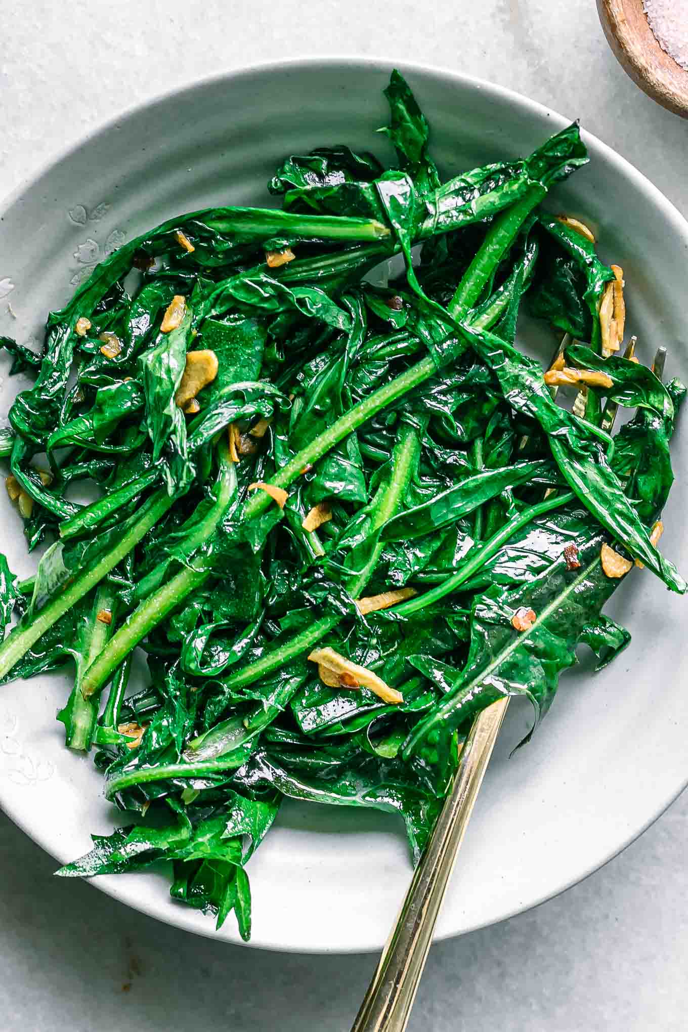 a close up photo of cooked dandelion greens in bowl