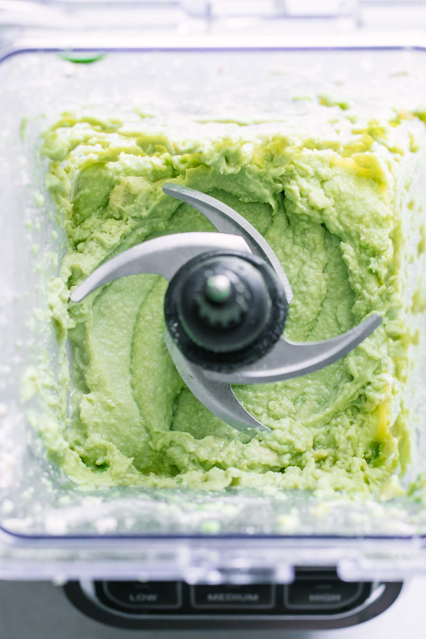 avocado crema sauce inside a blender after mixing