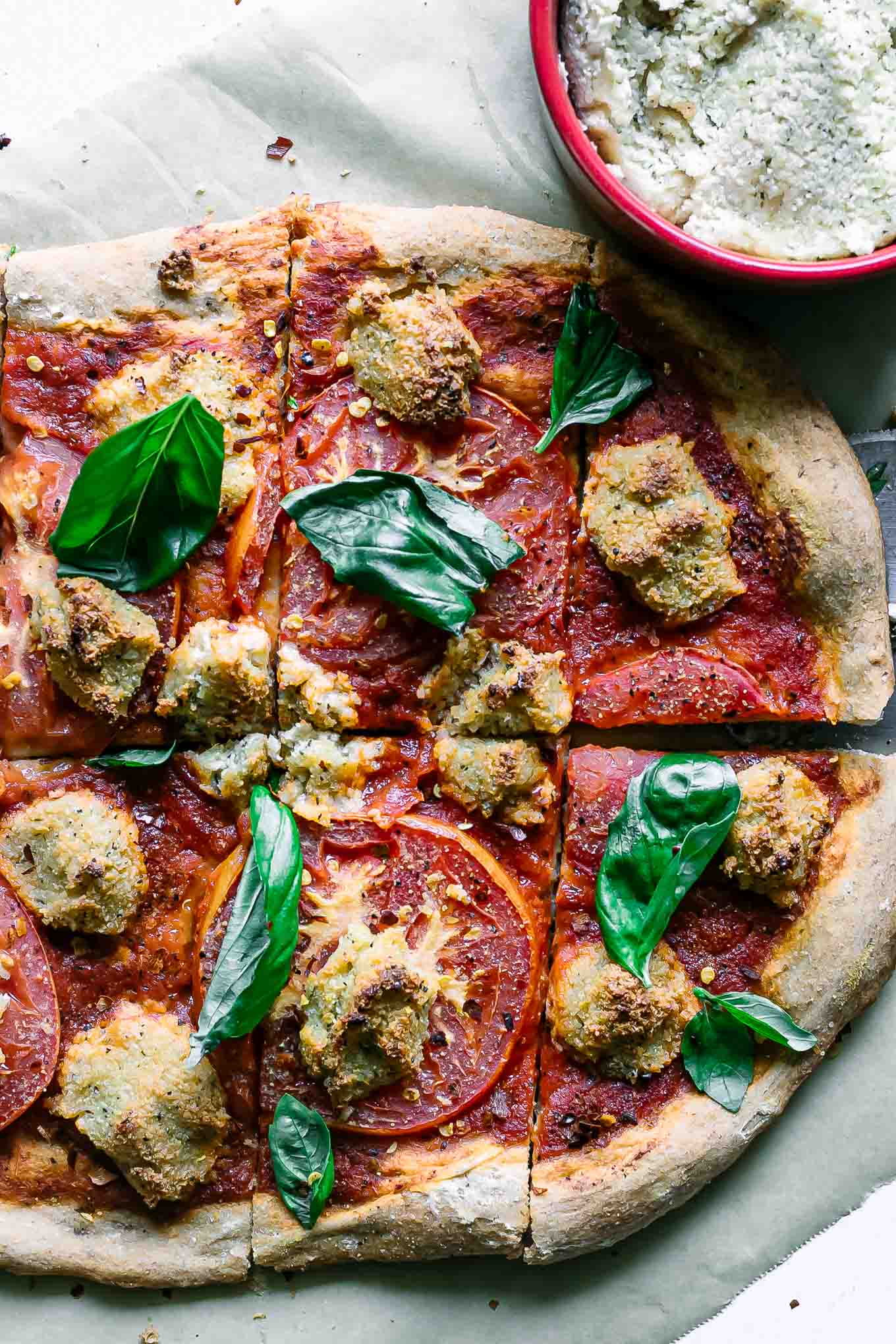 cut plant-based margherita pizza on a cutting board