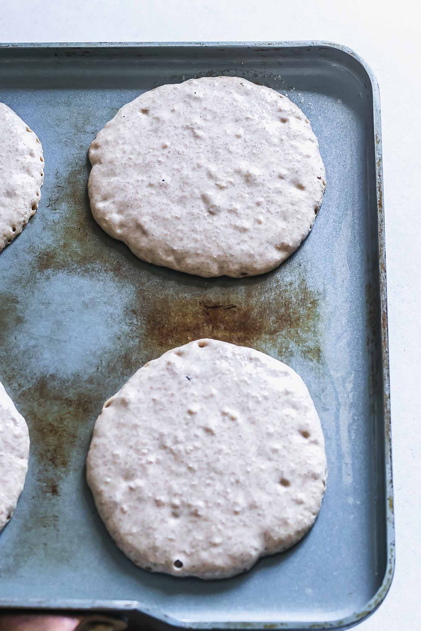a pan with small circles of pancake batter