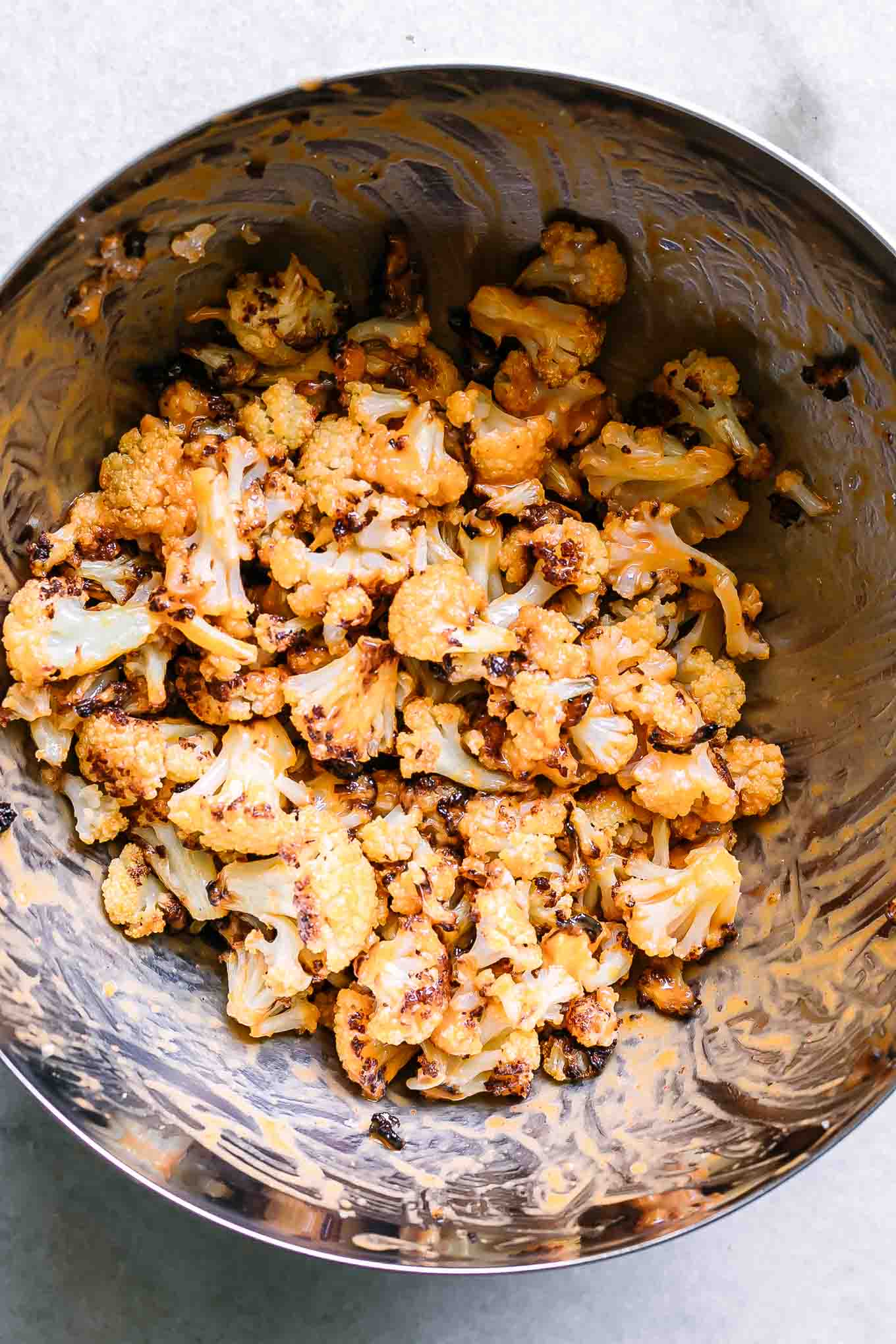a bowl with cauliflower and chickpeas tossed in romaine dressing
