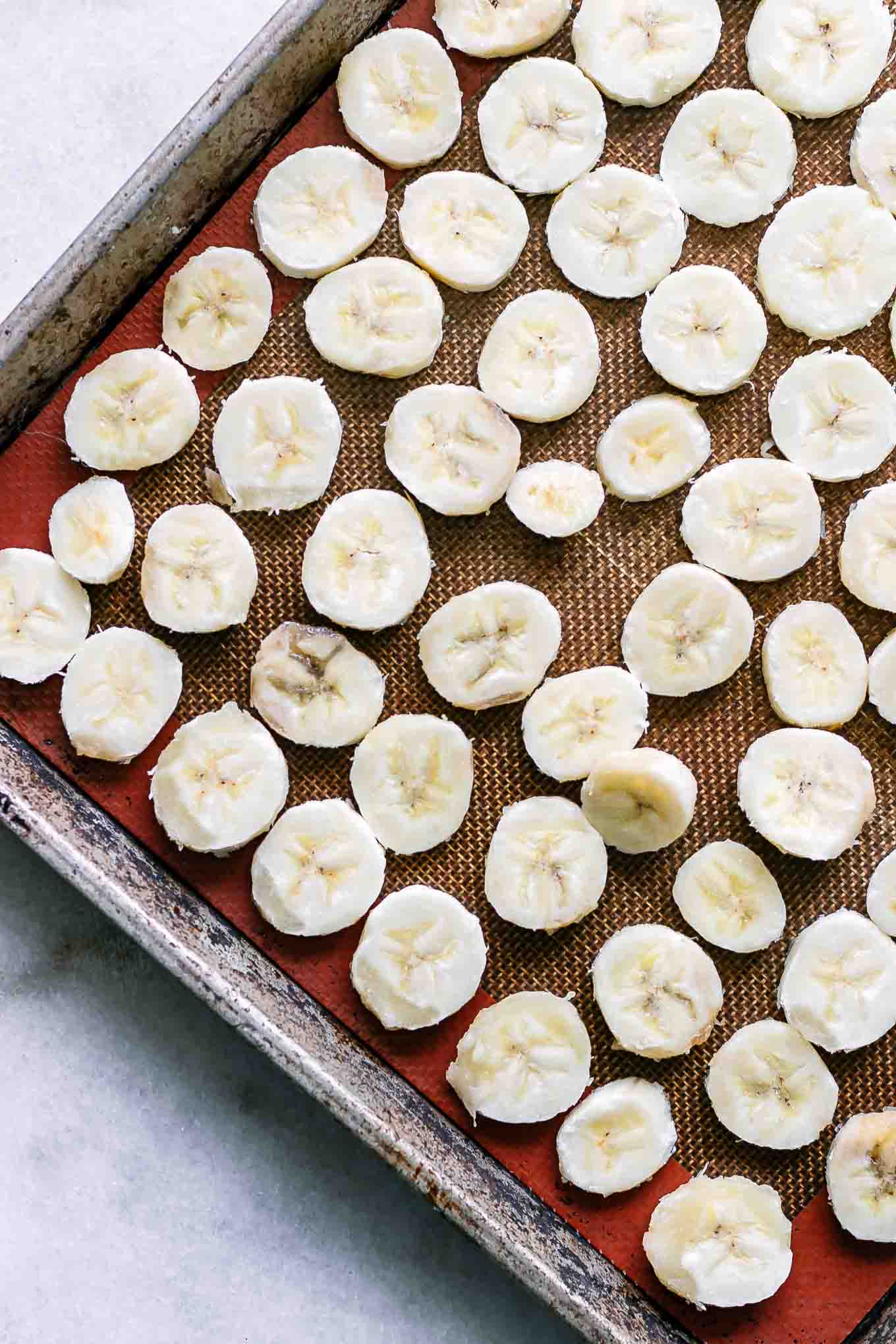 a baking sheet with sliced bananas