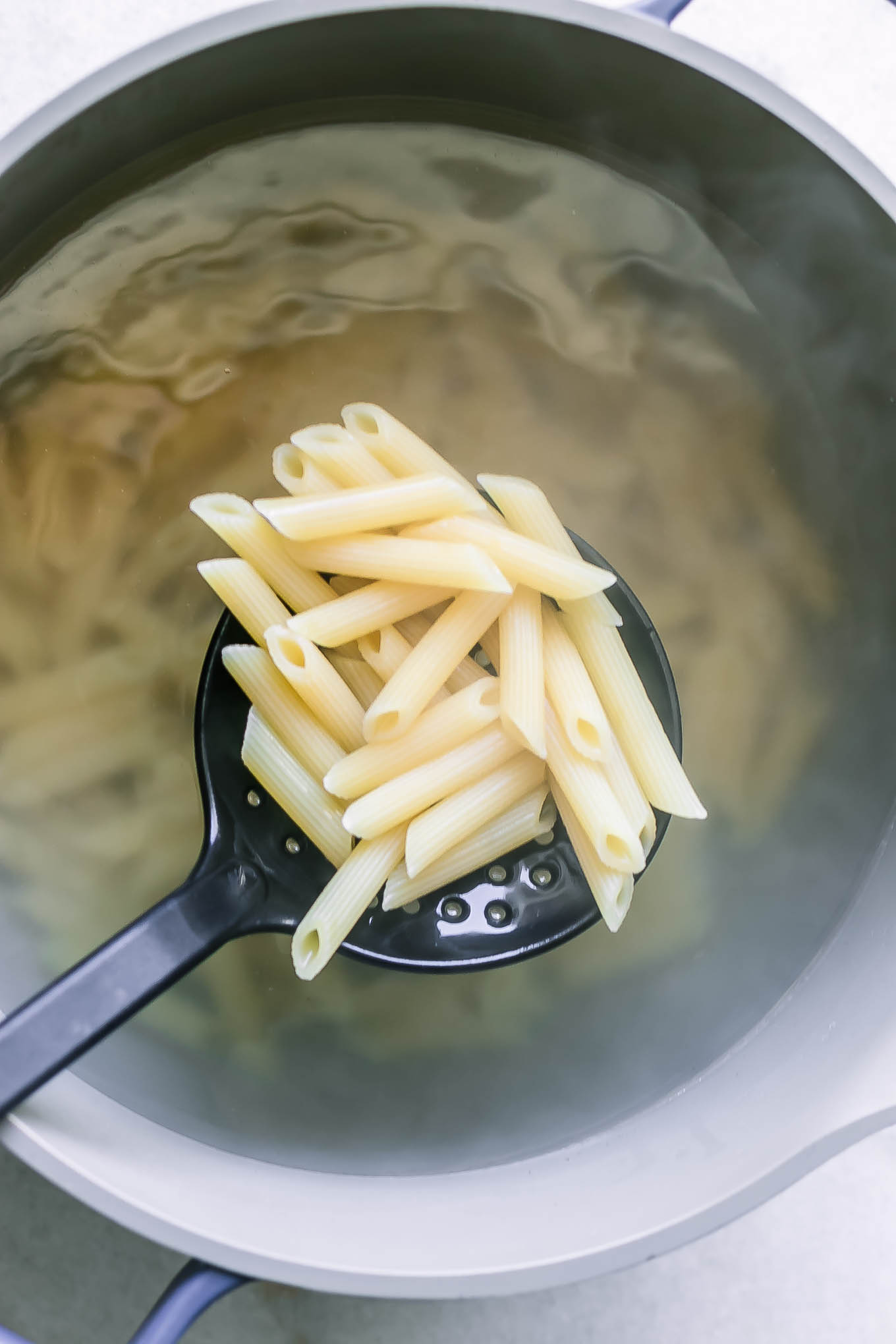a pot with penne pasta in boiling water