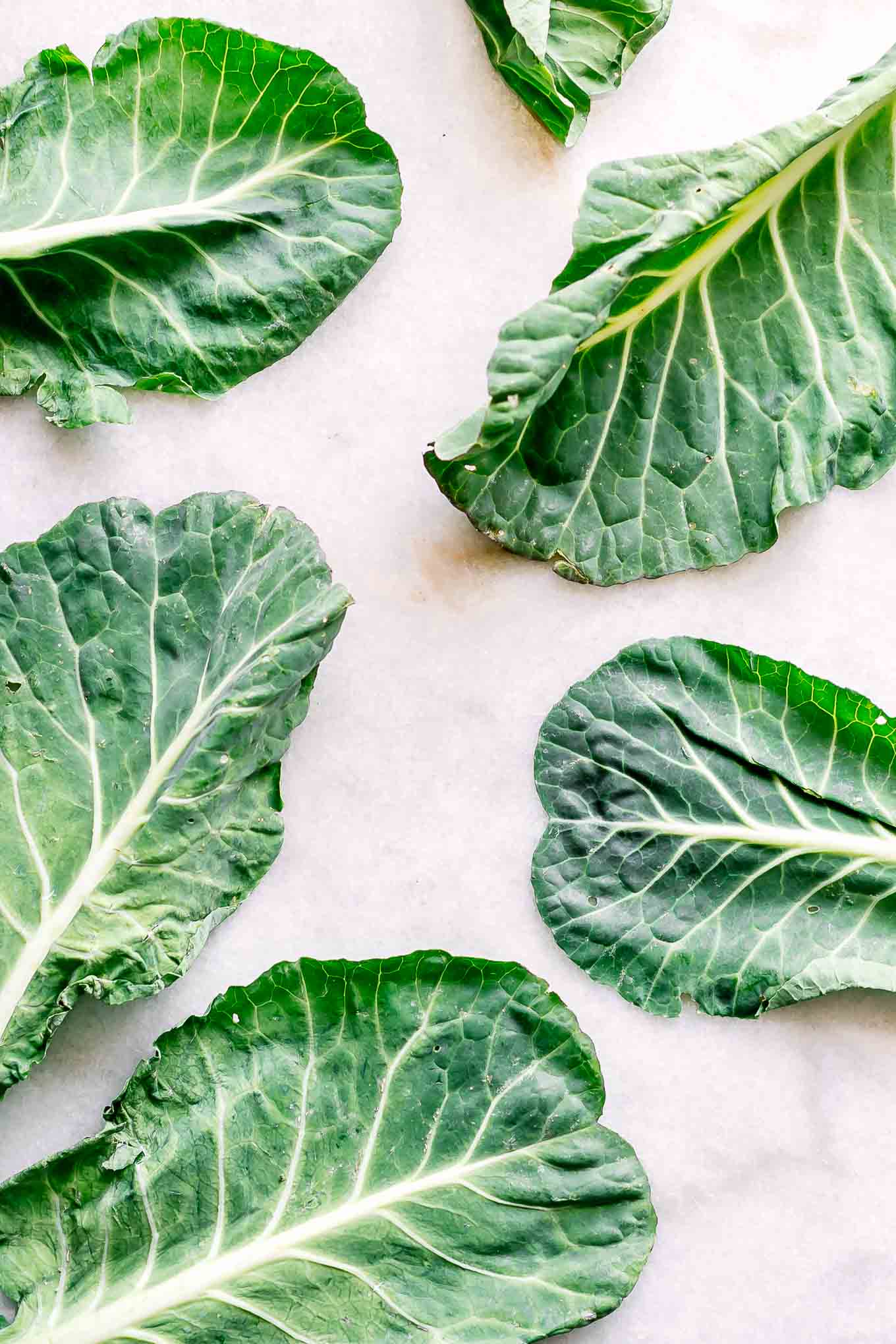 collard leaves on a white table