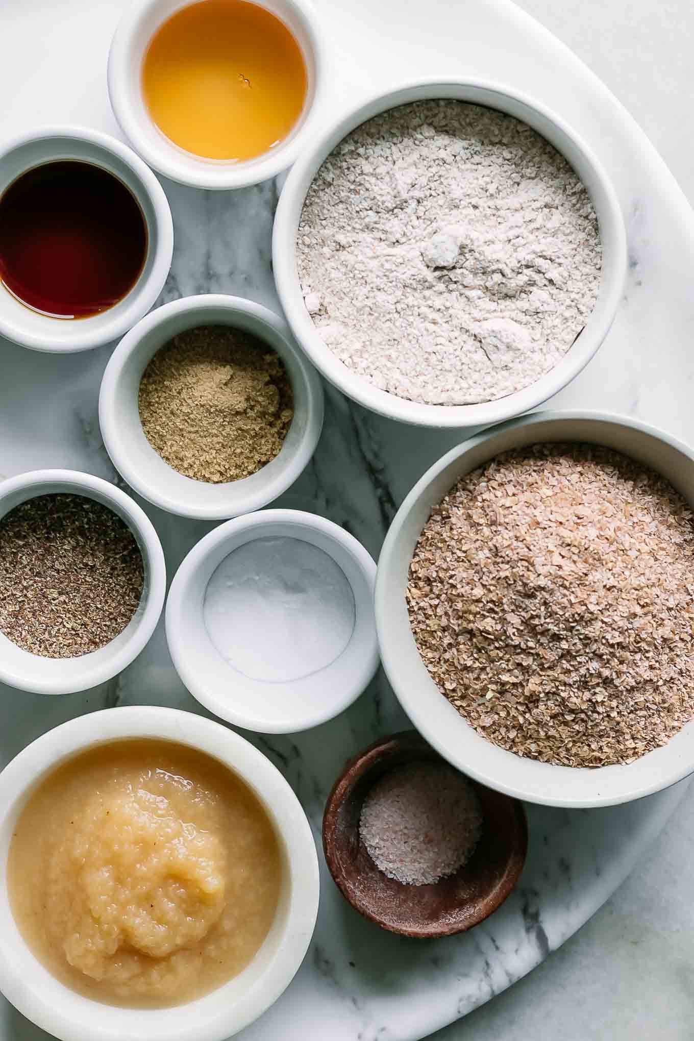 bowls of wheat bran, wheat flour, and other ingredients for plant-based bran muffins