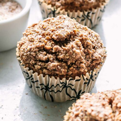 bran muffins in recycled paper muffin liners on a white table