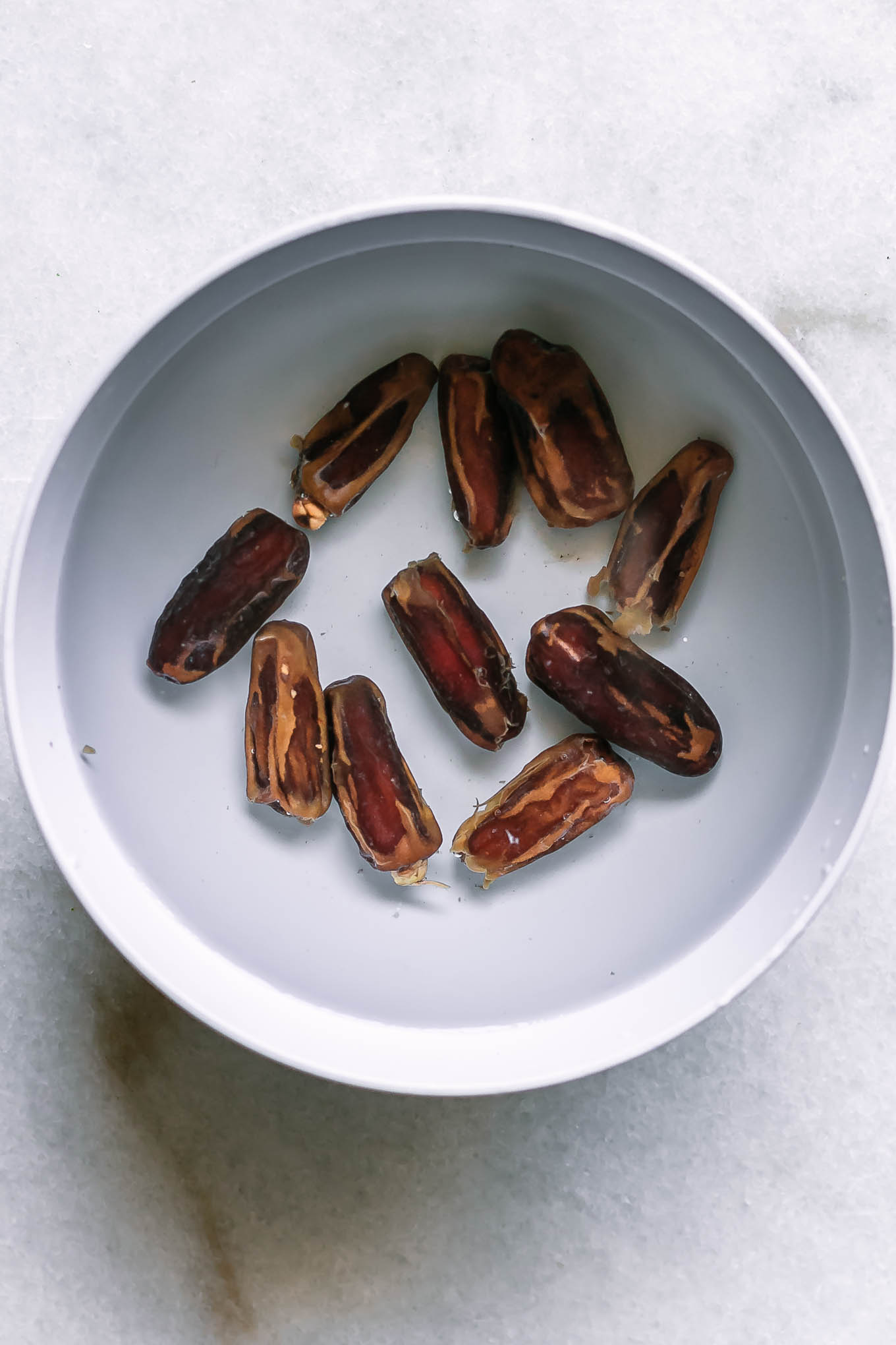 dates soaking in a bowl with hot water