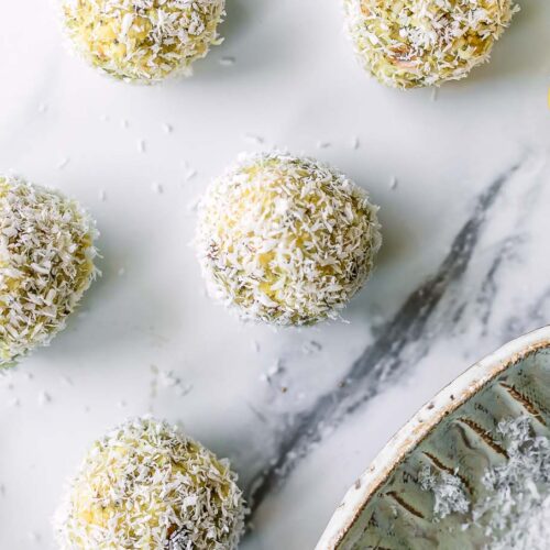 lemon coconut snack balls on a white table