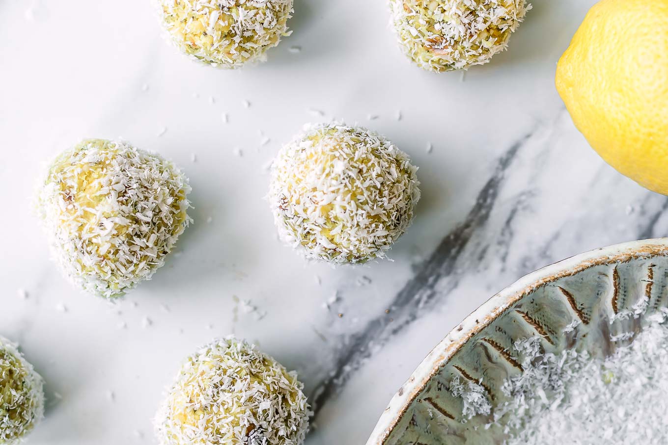 lemon coconut snack balls on a white table