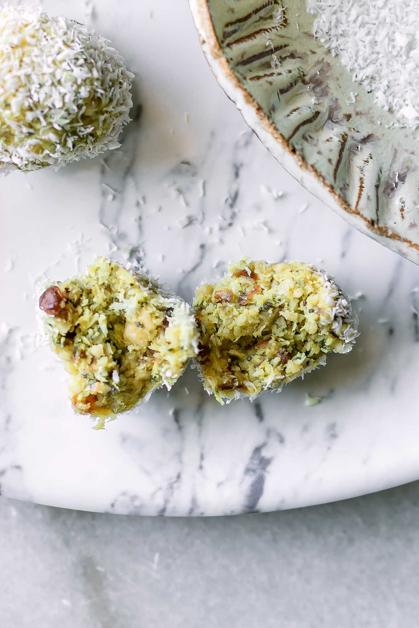 cashew coconut lemon balls on a white table