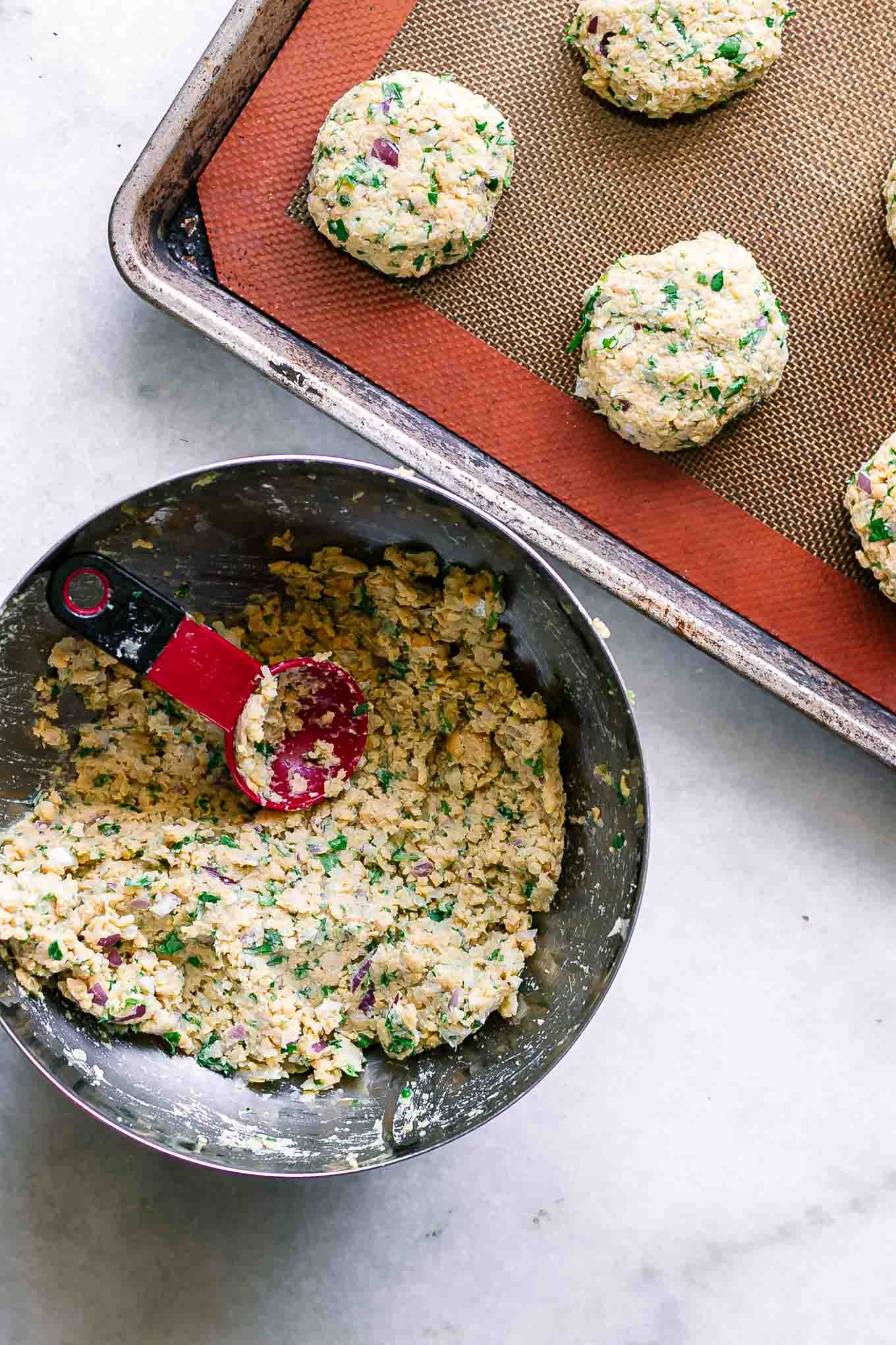 rolled falafel balls on a baking sheet before baking