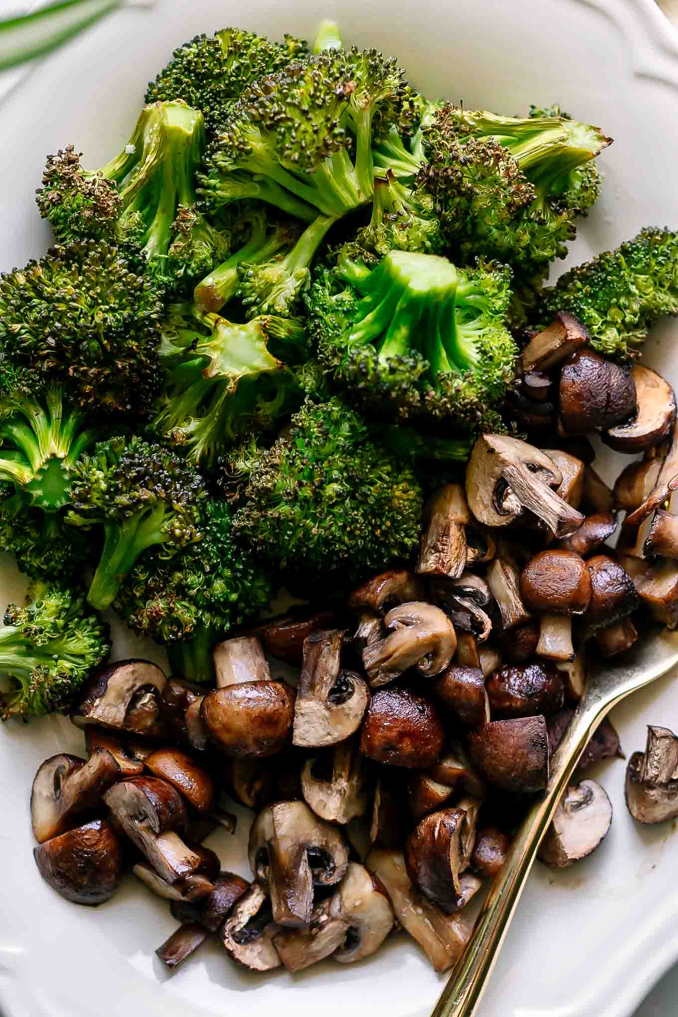 a close up photo of a roasted mushroom and broccoli side dish