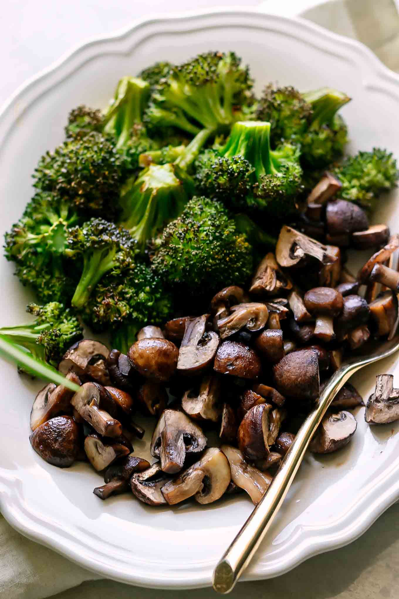 a close up photo of baked mushrooms and broccoli side dish
