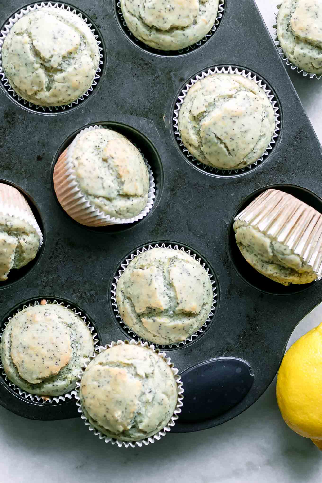 a muffin tin with vegan lemon poppyseed muffins after baking