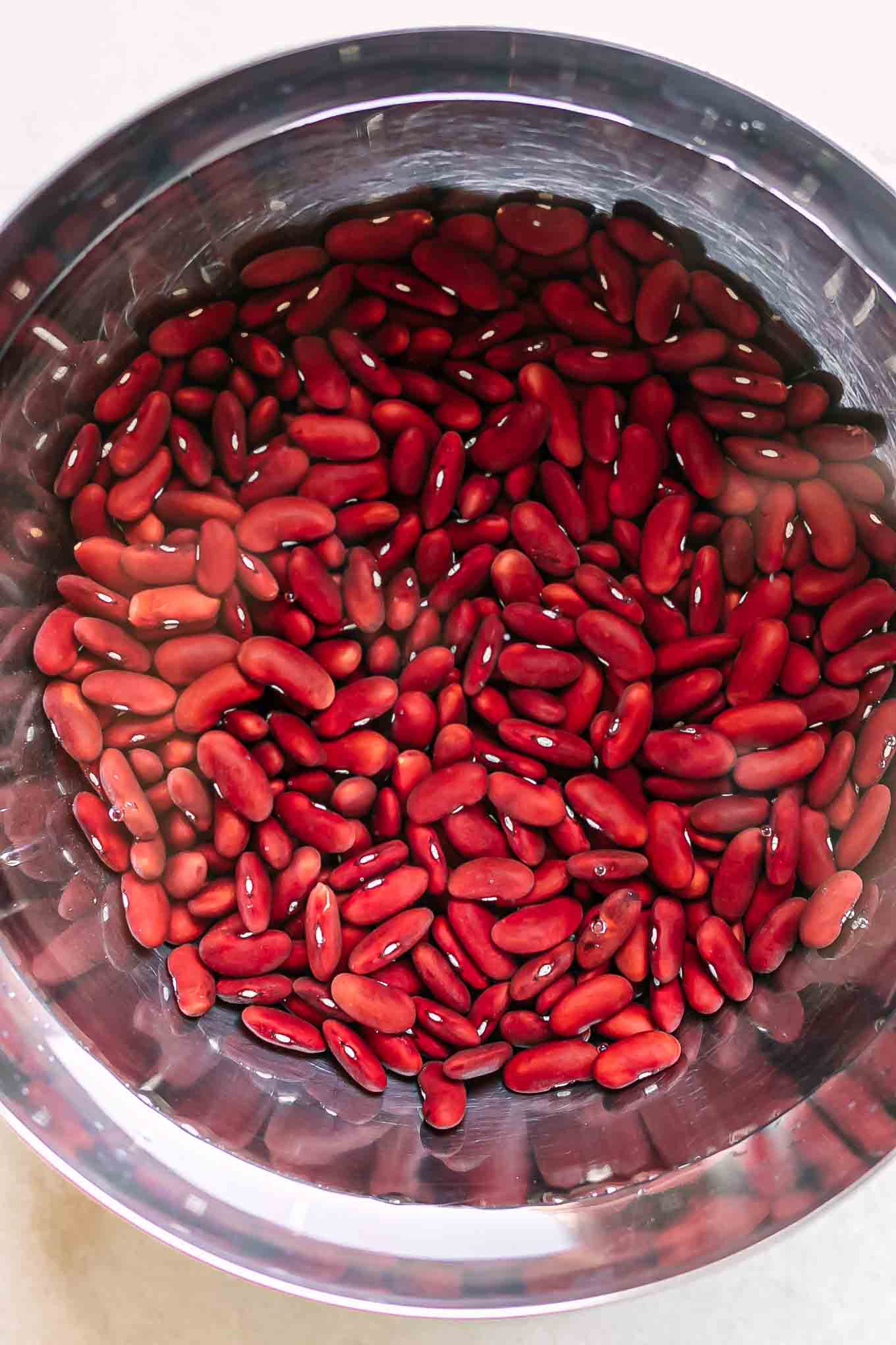 kidney beans soaking in water in a large mixing bowl