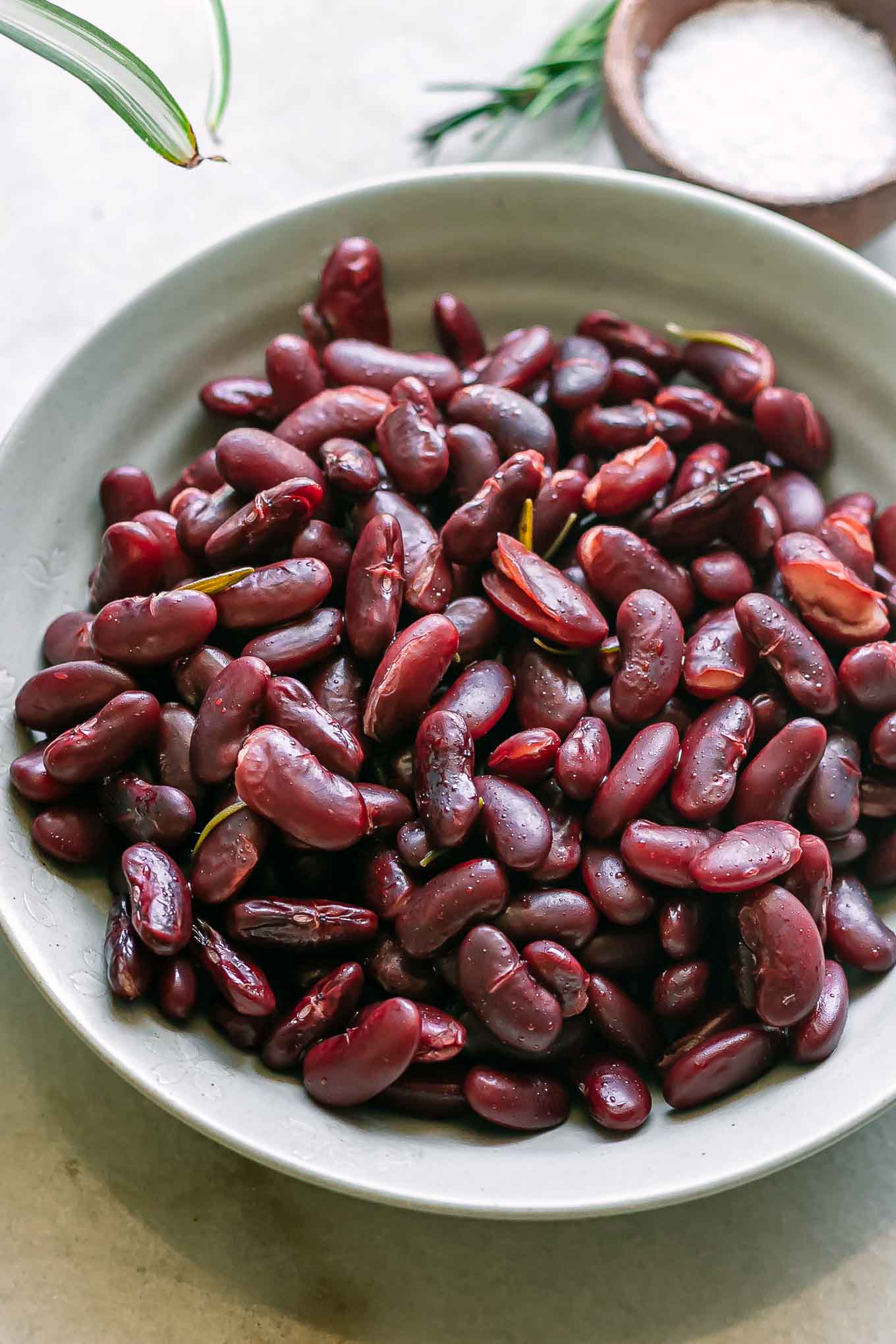 a bowl of kidney beans cooked in a pressure cooker on a white table