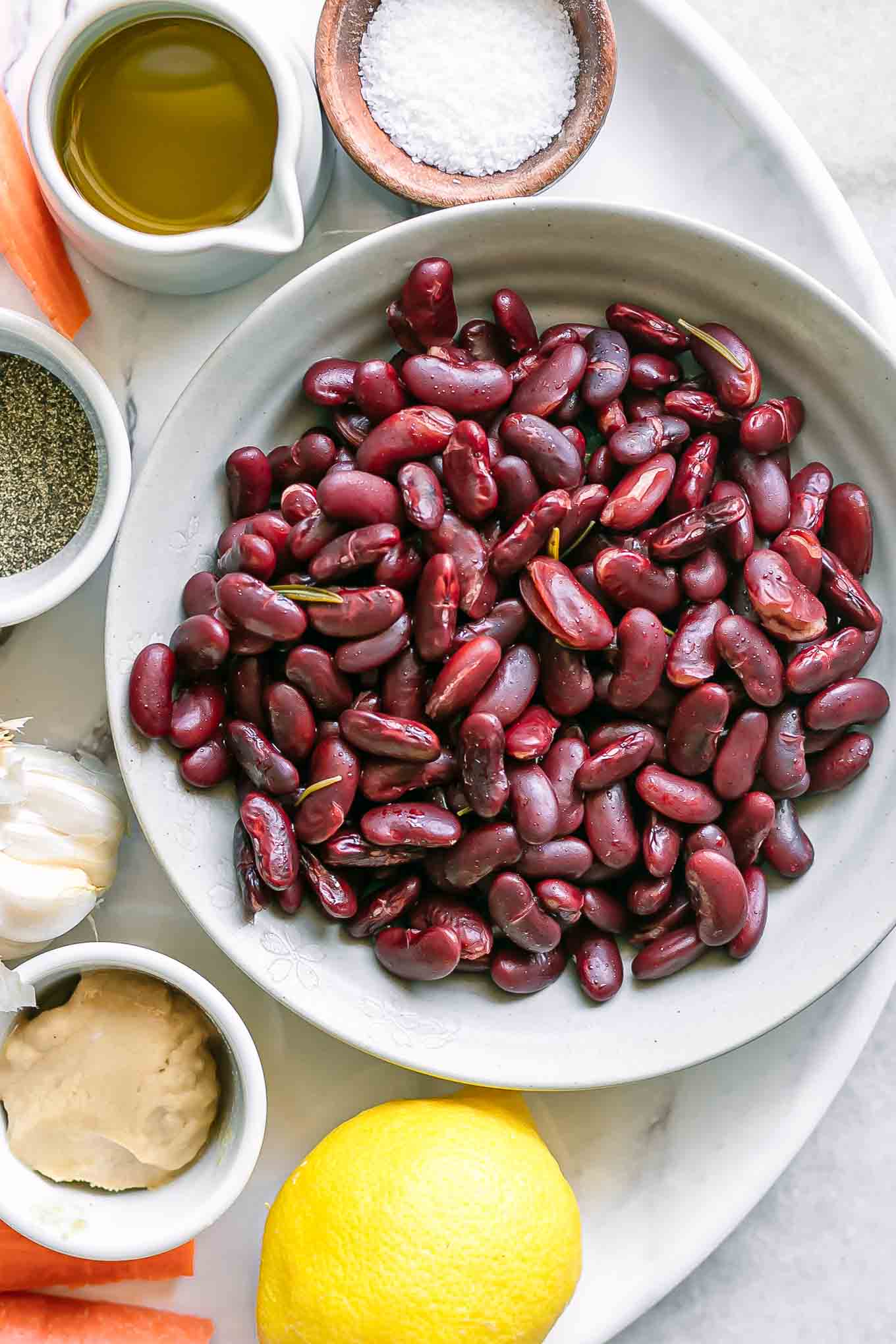 bowls of kidney beans, tahini, oil, salt, garlic, and lemon for kidney bean hummus