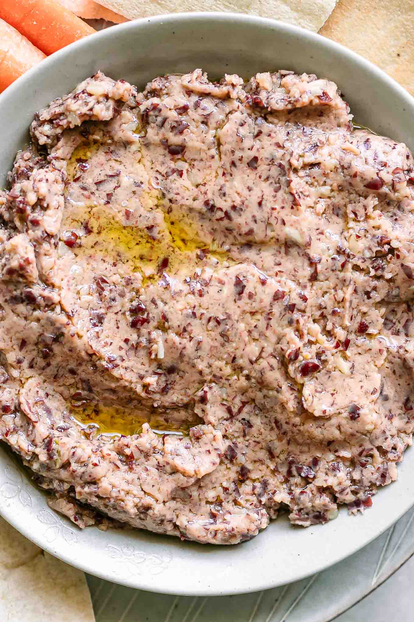 a close up photo of kidney bean hummus in a white bowl