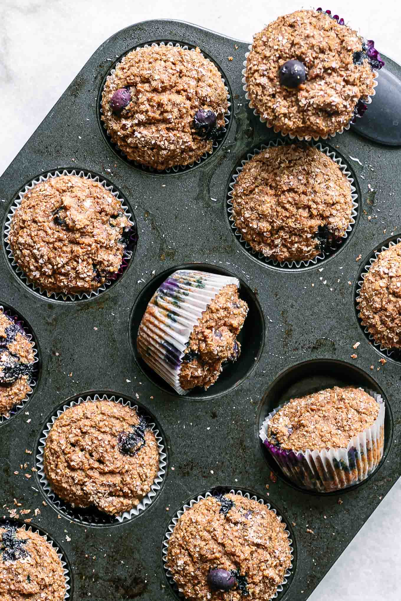 blueberry bran muffins in a muffin tin after baking