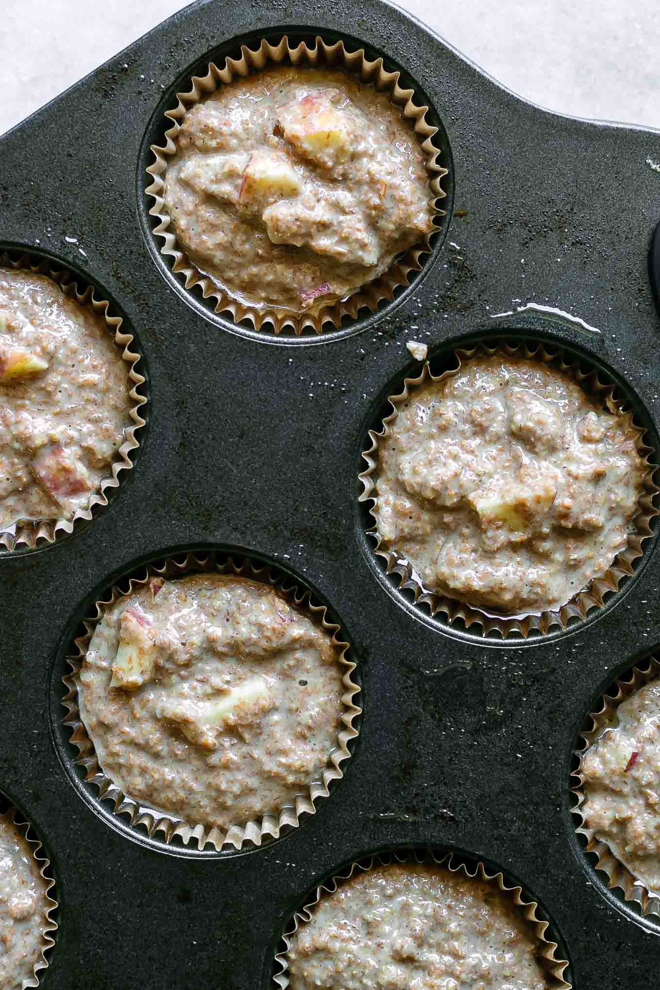 apple bran muffin batter in a muffin pan before baking