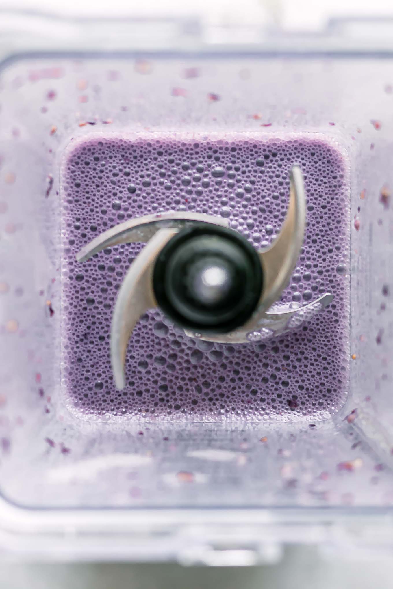 blended blackberry-flavored milk inside a blender