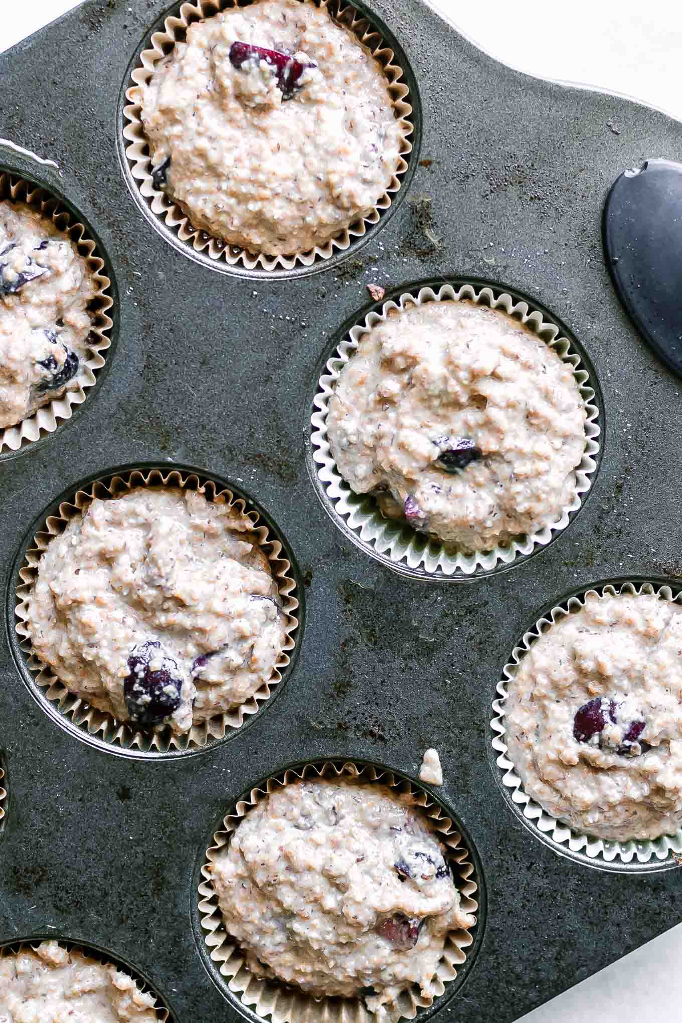 cherry bran muffin batter in a muffin pan before baking