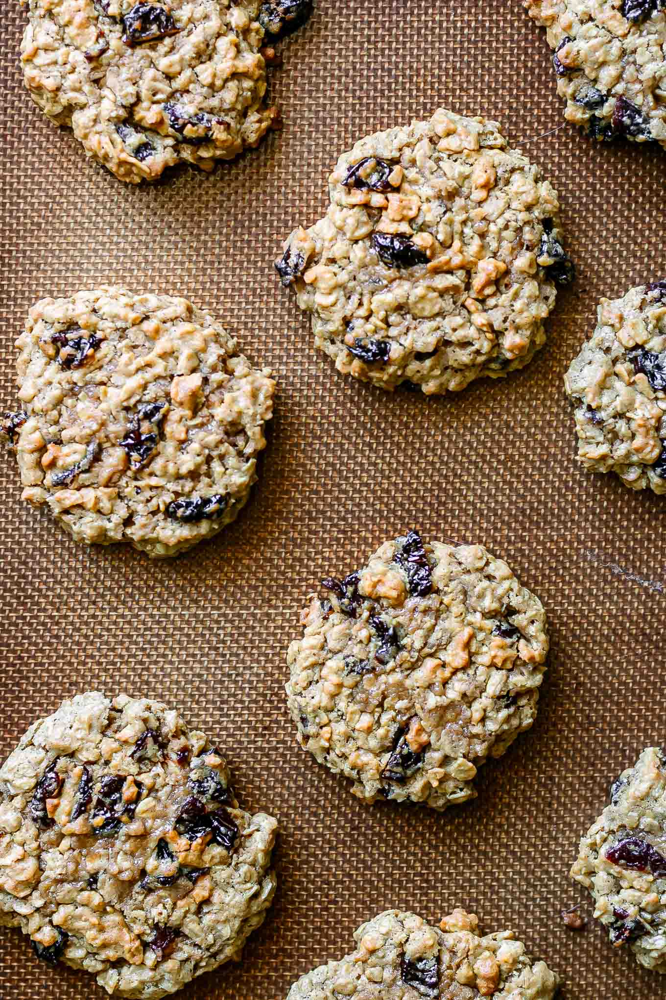 plant-based cherry oatmeal cookies on a baking sheet after cooking