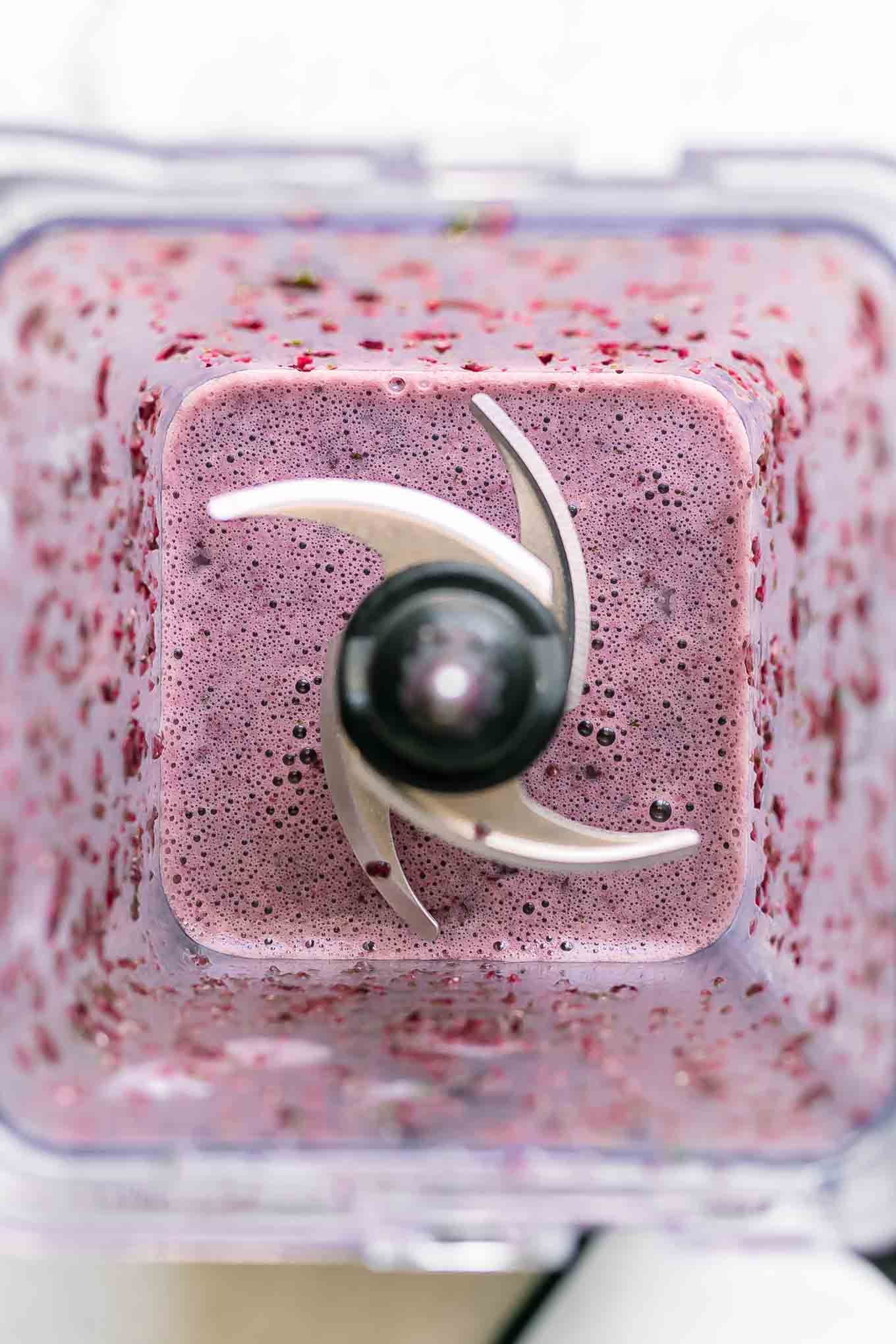 a purple spinach and cherry smooth inside a blender after blending