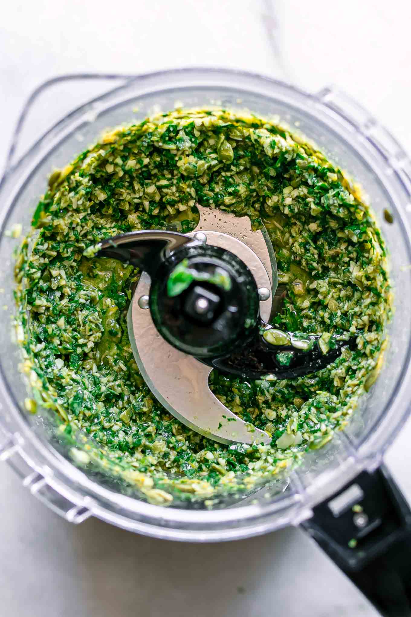 blended lemon pesto inside a food processor