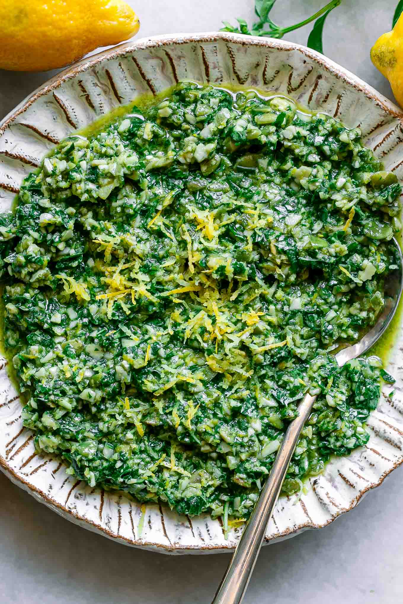 a close up photo of lemon pesto on a white plate