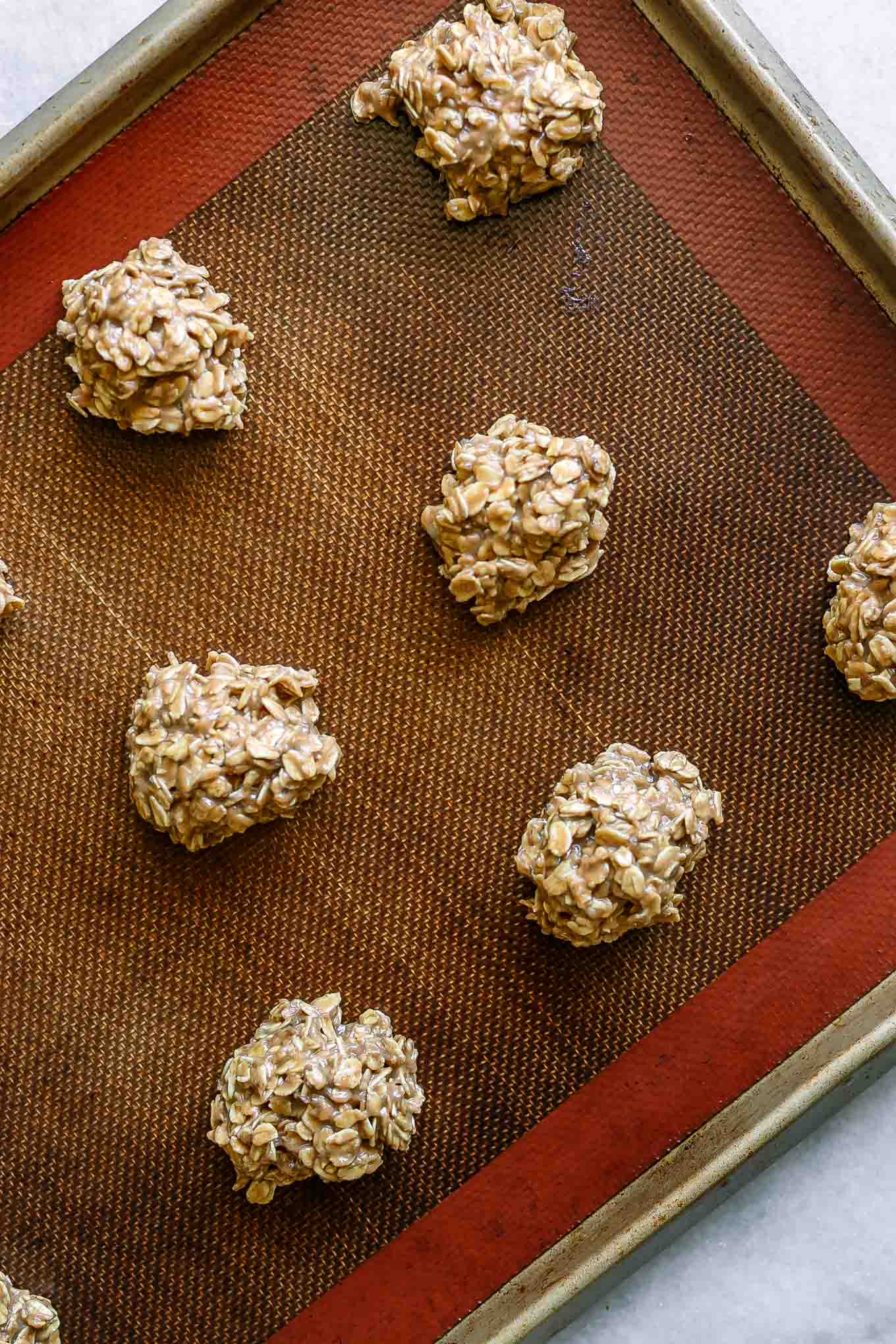 a baking sheet with oatmeal cookie batter with bananas before baking