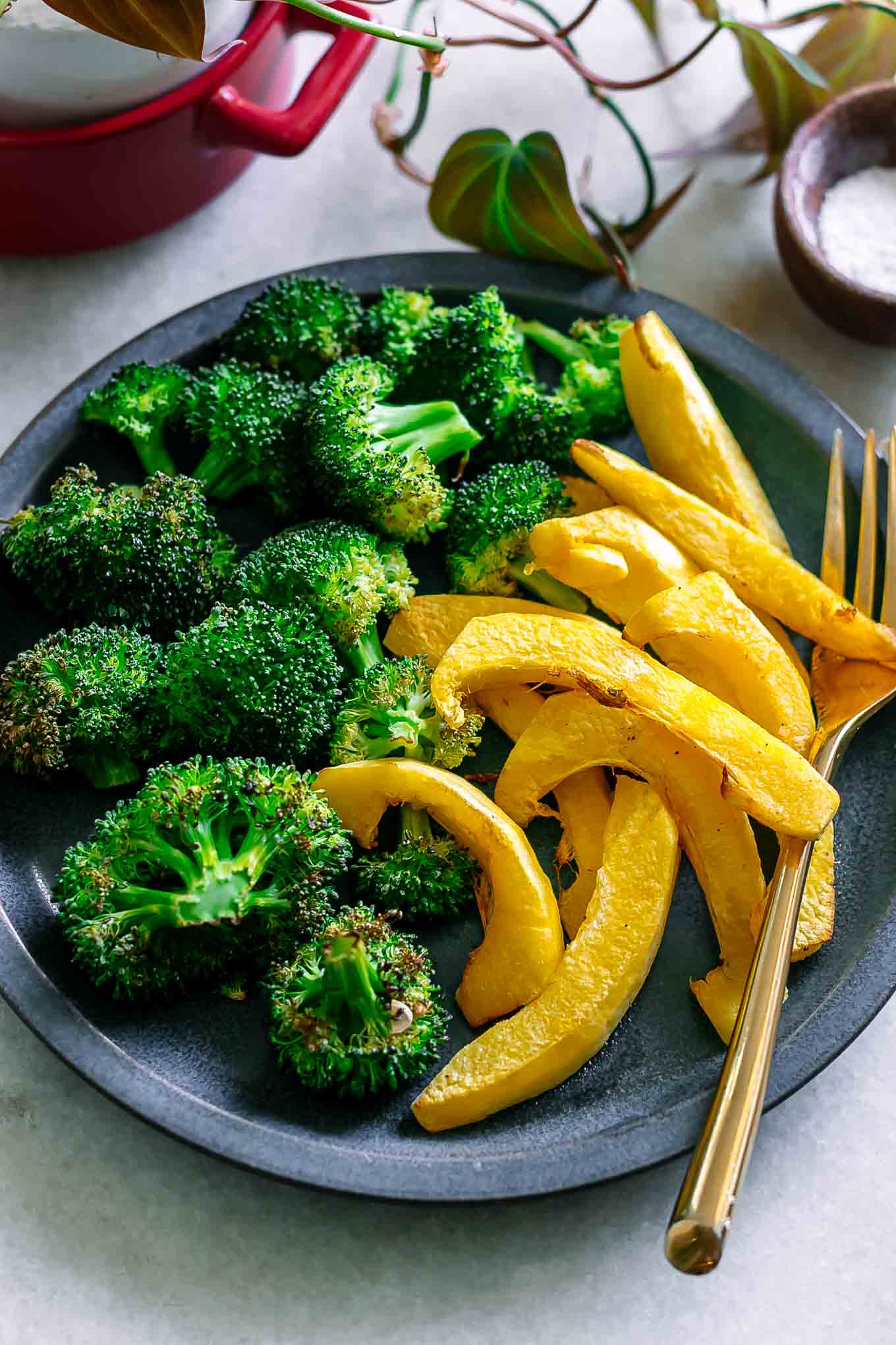 baked acorn squash and broccoli side dish on a white table