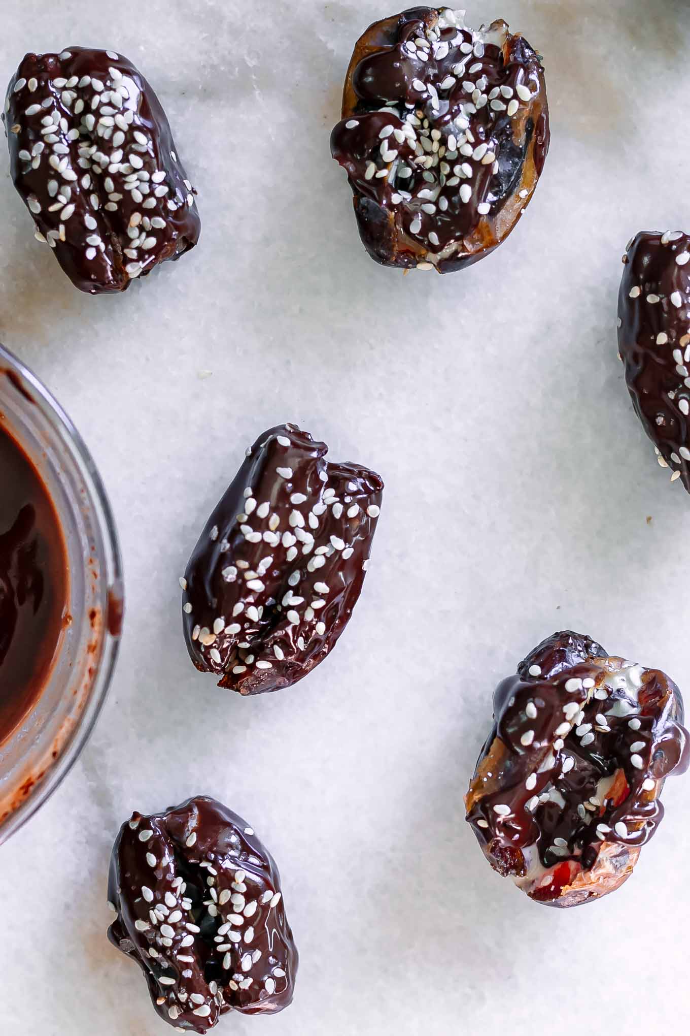chocolate covered dates stuffed with tahini on a white table