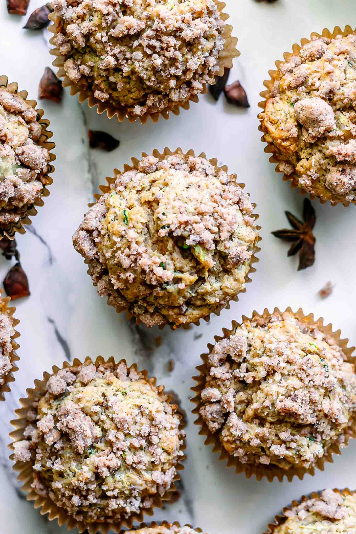 zucchini muffins with on a white marble tabletop