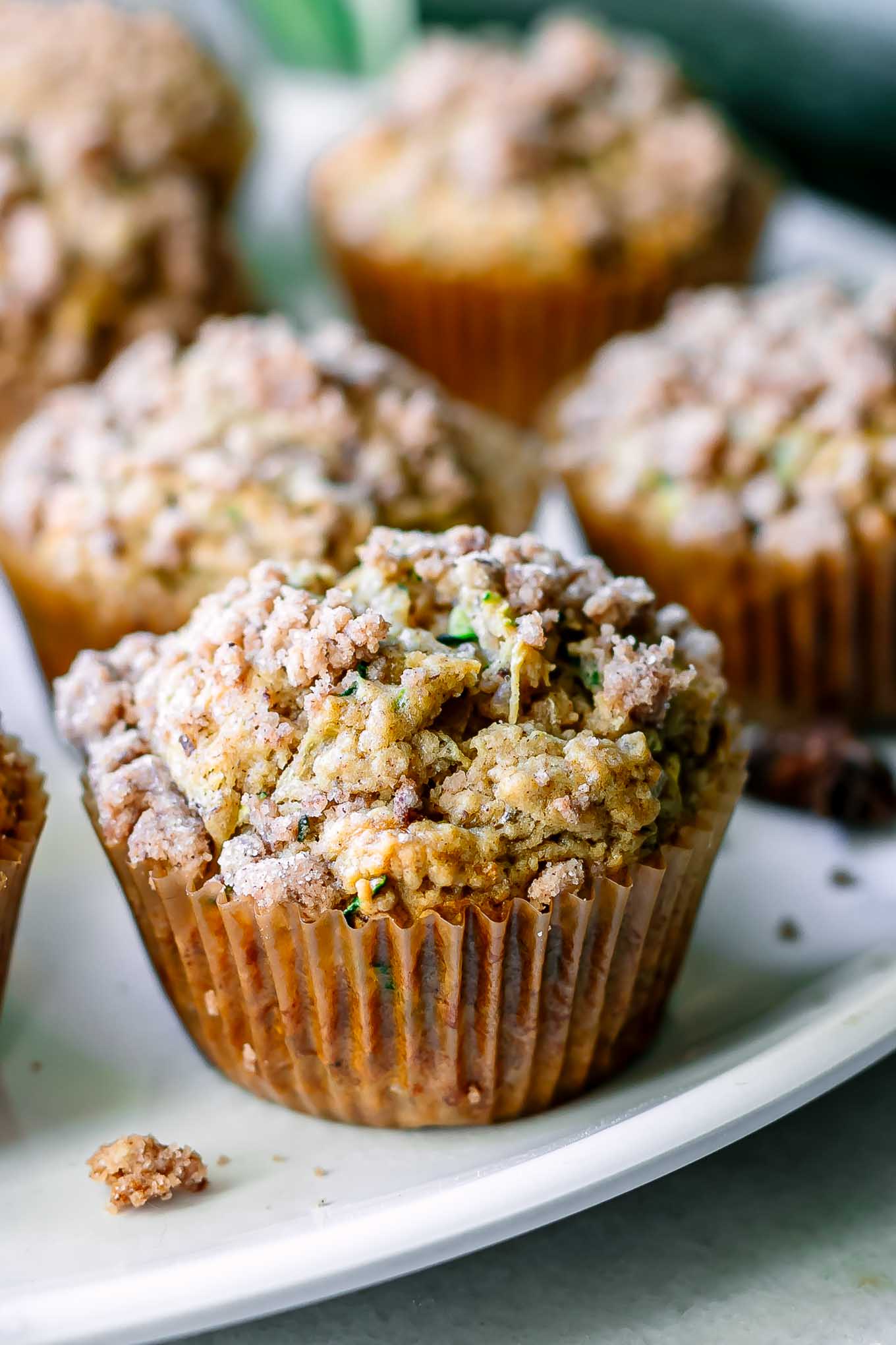 a plant-based zucchini muffin on a white table
