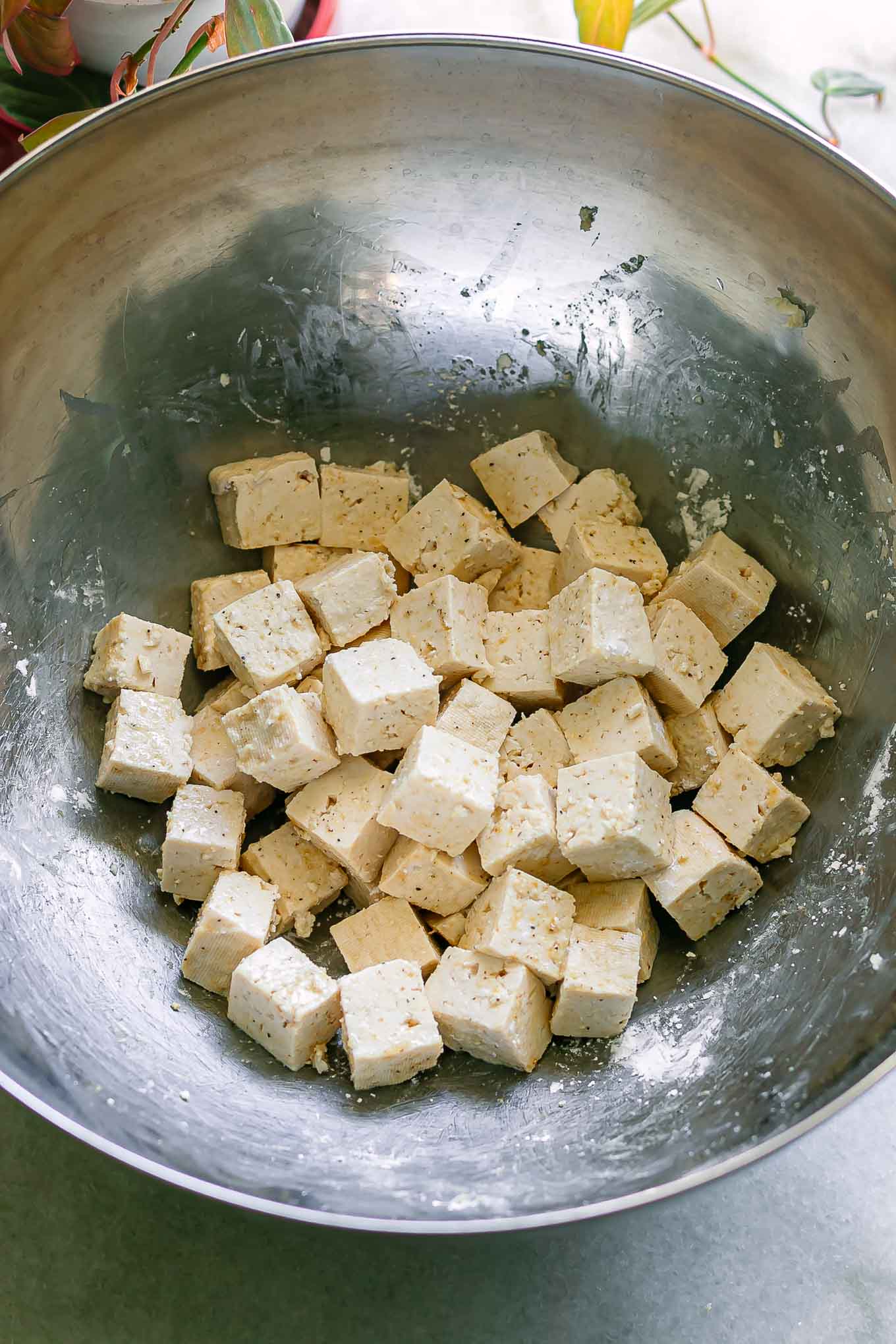 cut tofu cubes in a bowl with cornstarch and spices