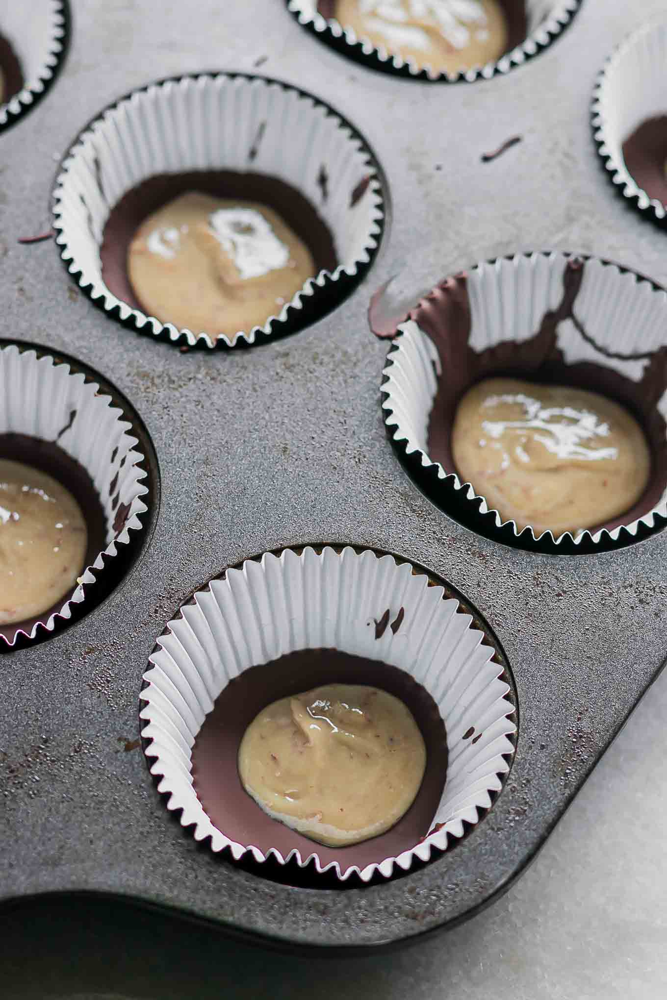 dark chocolate and tahini inside muffins liners in a muffin tin