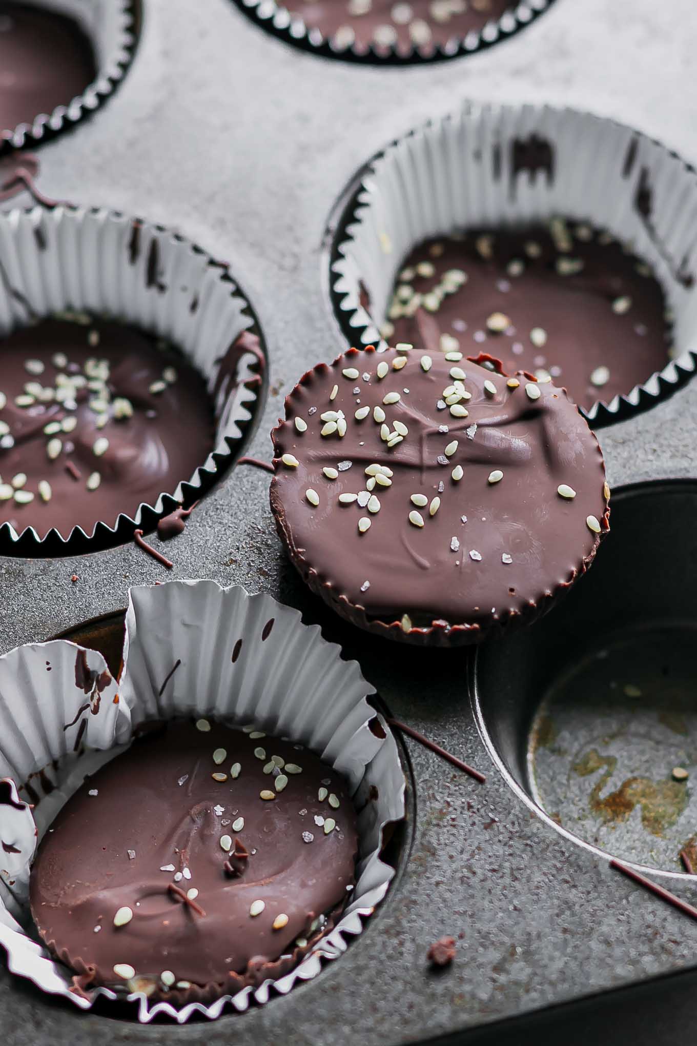 dark chocolate tahini cups in a muffin tin after freezing