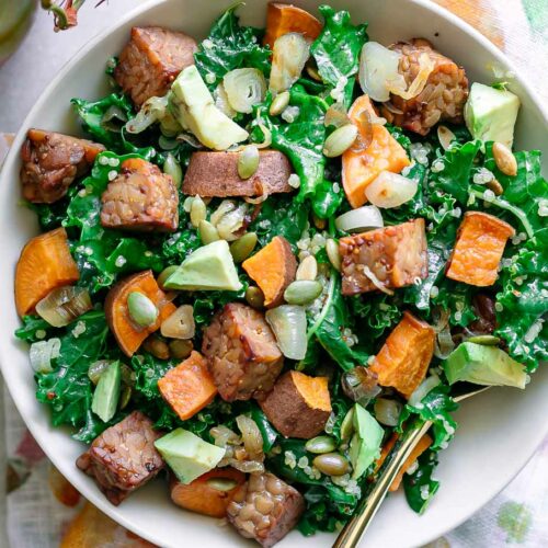 a kale and quinoa bowl with tempeh and sweet potatoes