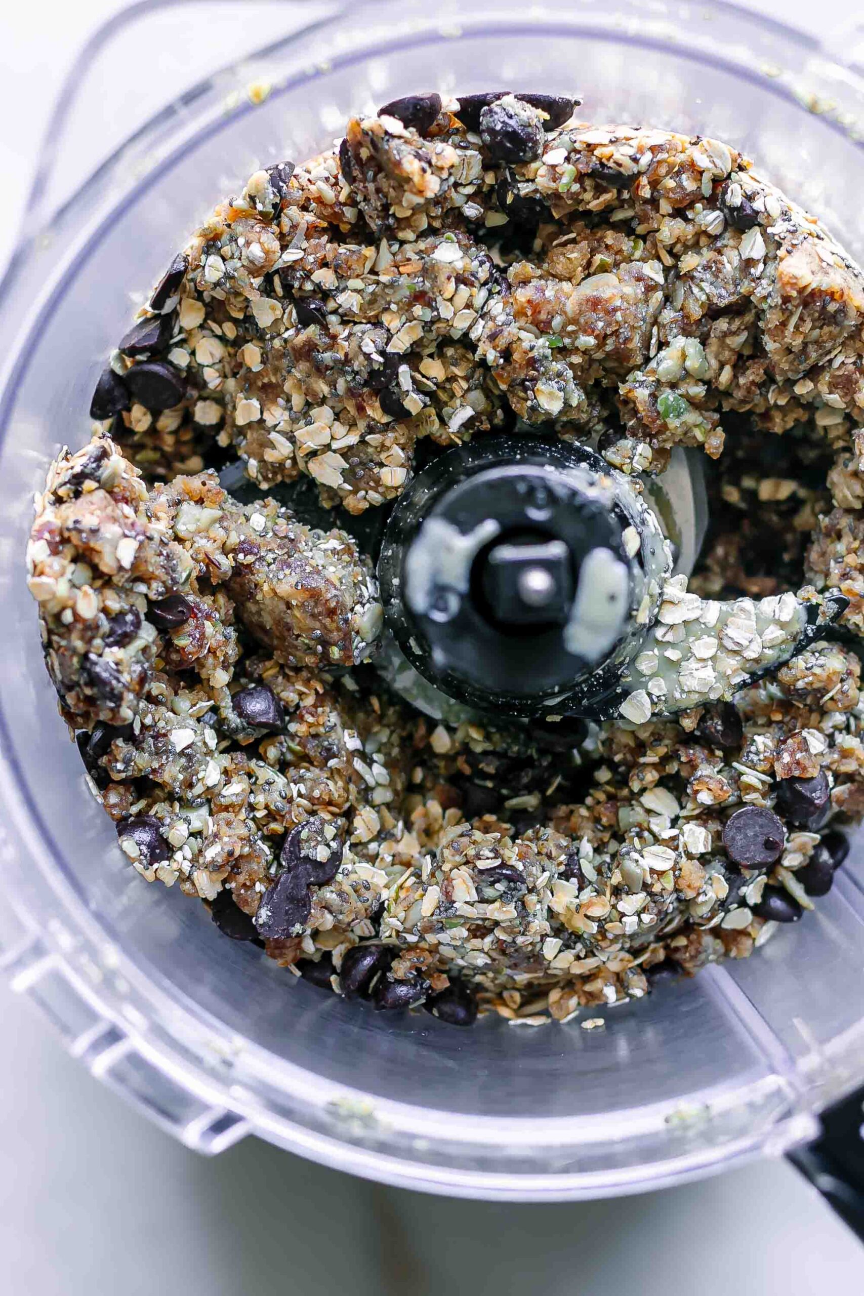 seeds, rolled oats, dates, tahini, and other ingredients in a food processor
