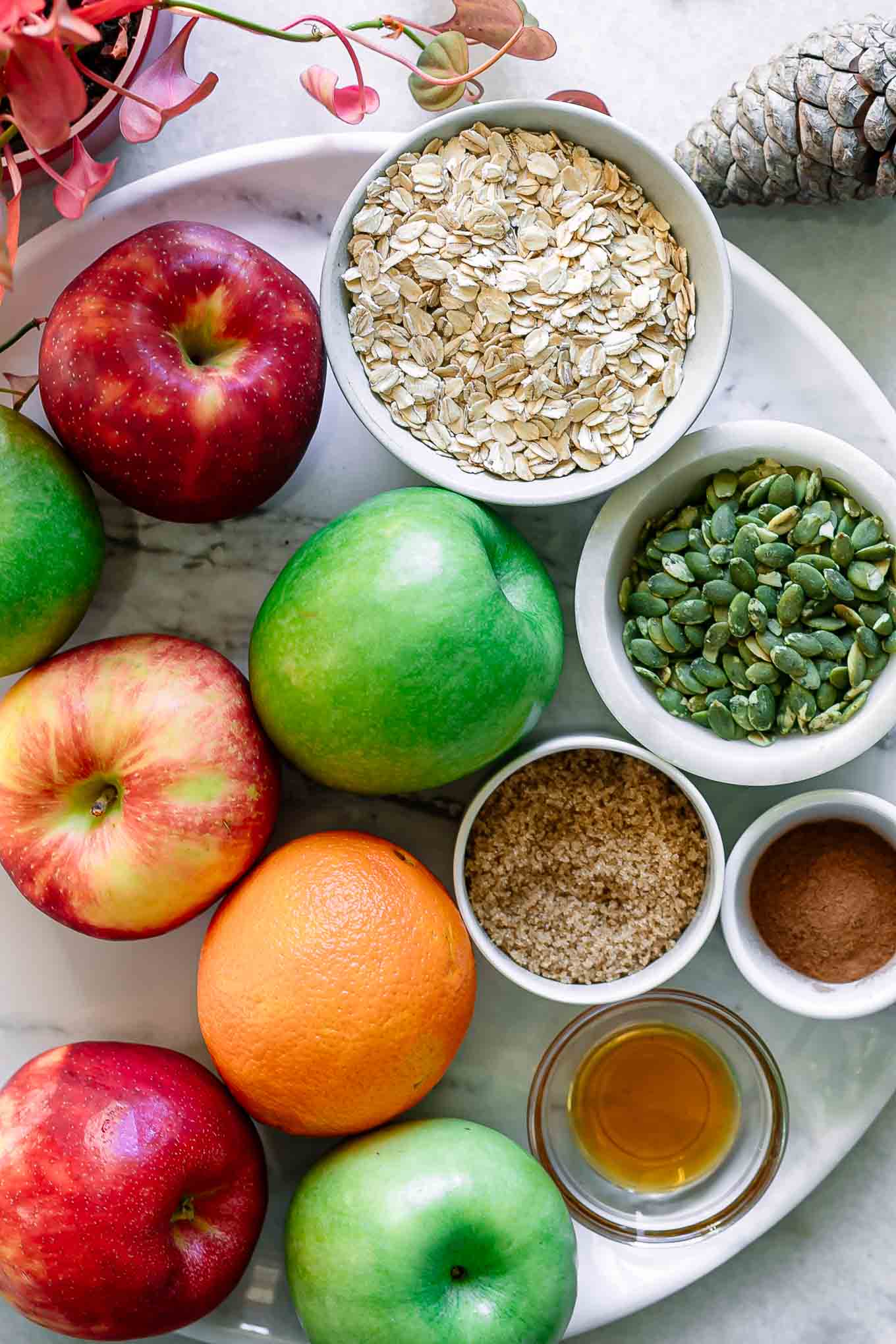 apples, maple syrup, rolled oats, and other ingredients for hasselback baked apples with homemade granola