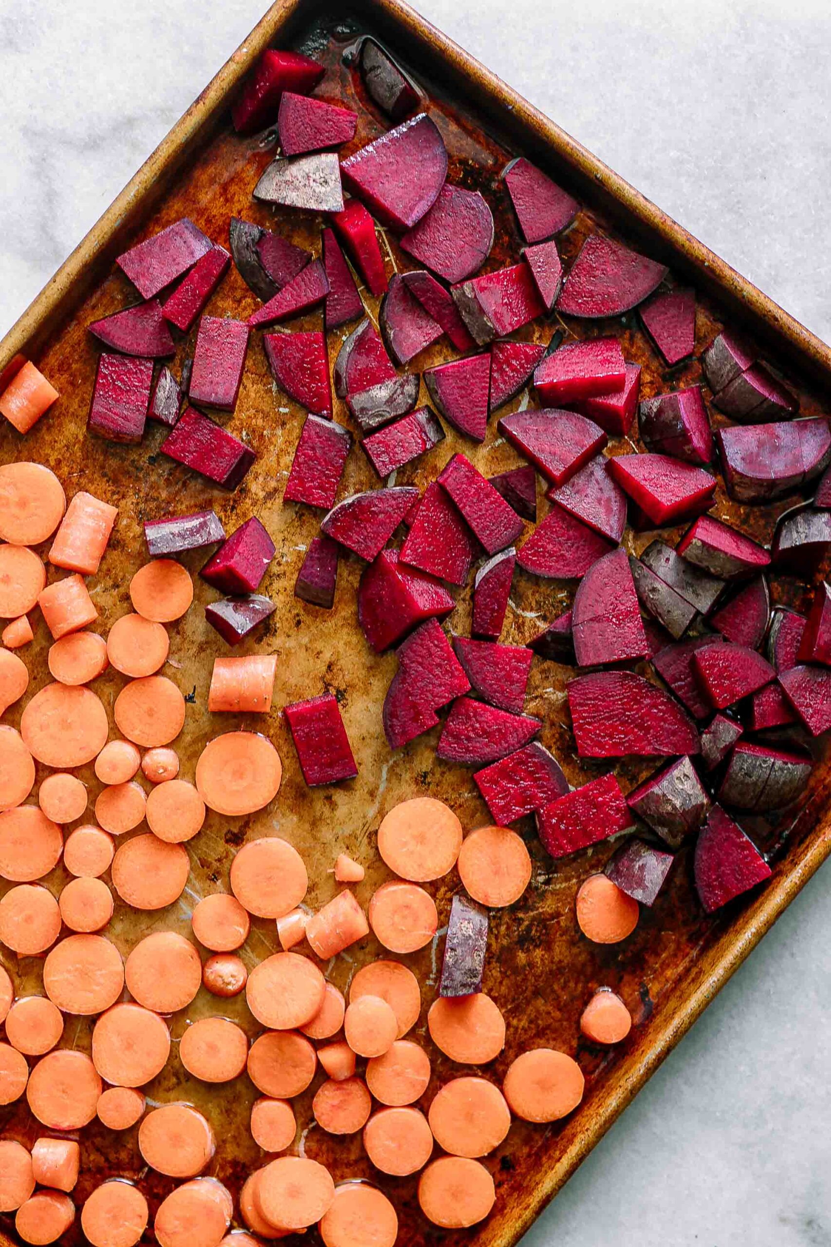 cut beets and carrots on a sheet pan before roasting